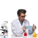 front-view-middle-aged-scientist-medical-suit-holding-mask