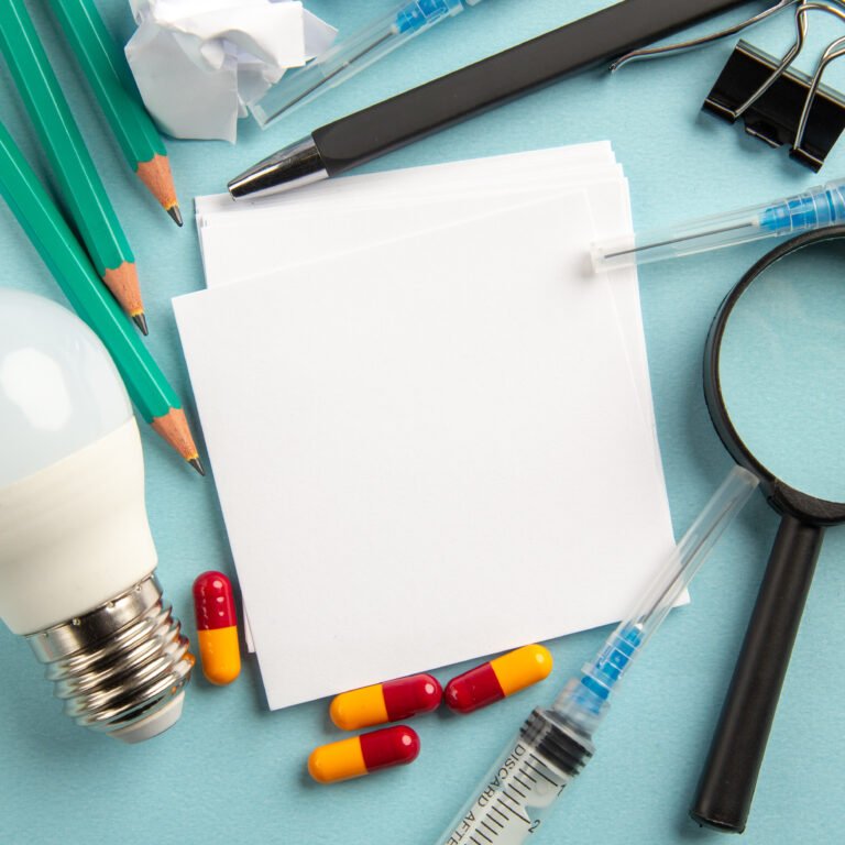 top-view-white-stickers-with-pencils-injections-pills-blue-background-lab-science-pandemic-hospital-virus-pill-covid-color-health